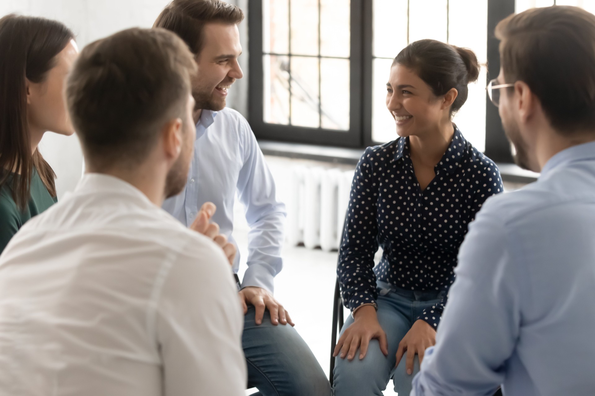 Friendly diverse people taking part in group therapy session